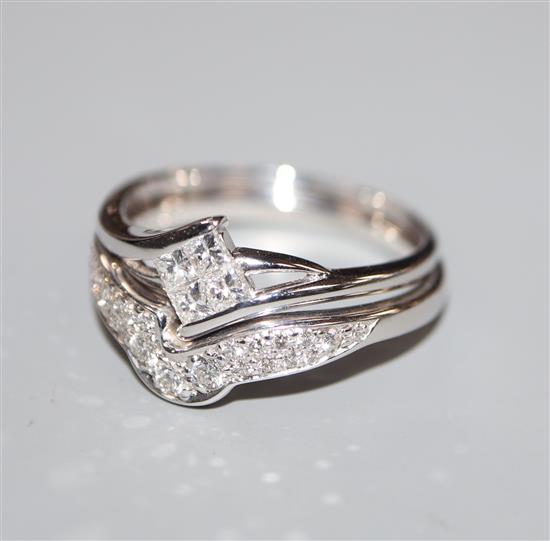 A modern 18ct white gold and diamond set wedding and engagement ring set, size M/N.